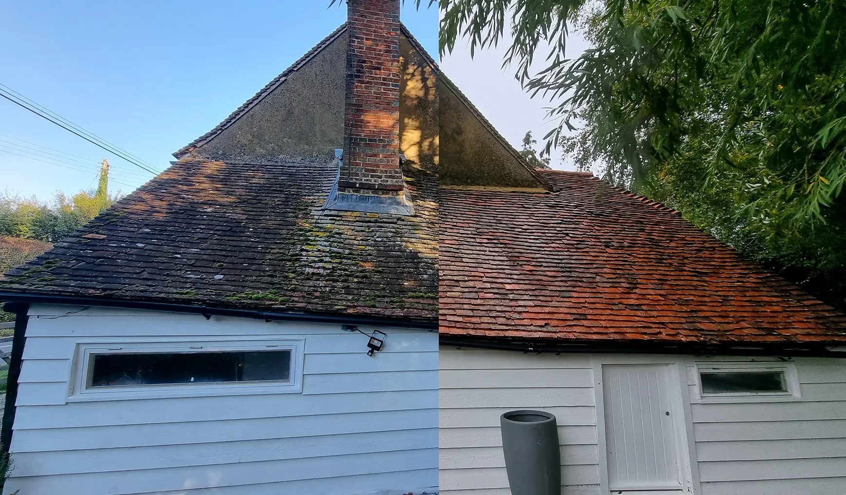 A clay tiled roof above a white weatherboard outbuilding before and after cleaning, with the cleaned side showing red tiles